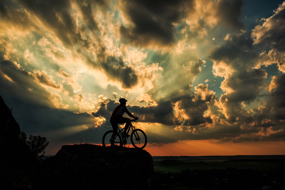 Silhouette of a bike on sky background on sunset, to illustrate that private emailing can be fun again.