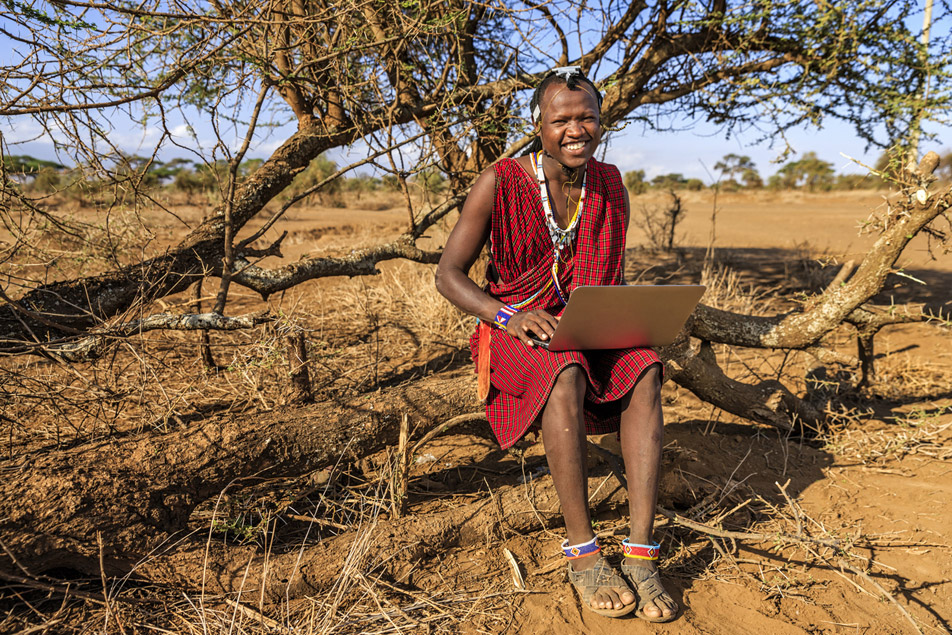 African warrior from Maasai tribe using laptop, central Kenya, Africa, using his laptop to send email with Privacy Control.
